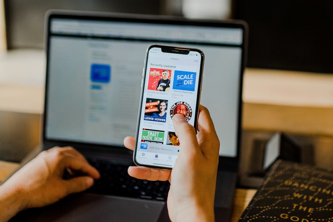 person-using-smartphone-and-laptop-at-the-same-time-qk1ohzmopbo